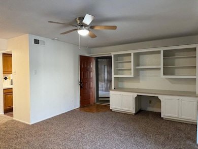 Unfurnished office with ceiling fan, visible vents