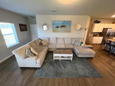Living room with dark wood-type flooring and base