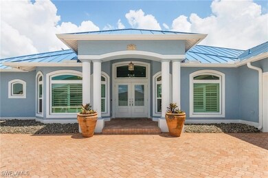 Doorway to property with metal roof, stucco siding