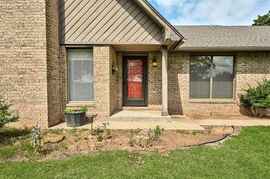 Entrance to property featuring brick siding and a shingled roof