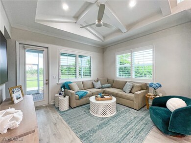 Living room featuring lofted ceiling with beams, h