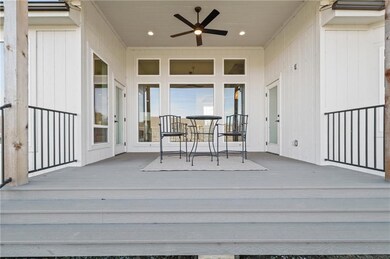 Wooden terrace featuring a ceiling fan