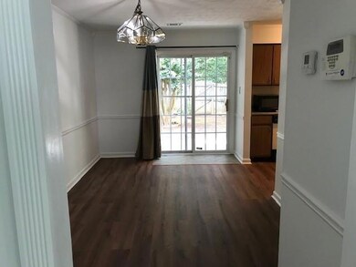 Unfurnished room with dark wood-type flooring and a chandelier