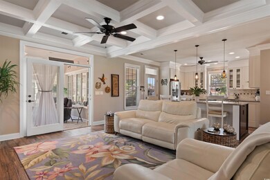 Living room featuring a ceiling fan, wood-type flooring, baseboards, beamed ceiling, and recessed lighting