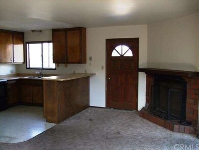 Entry, kitchen and fireplace in living room of top