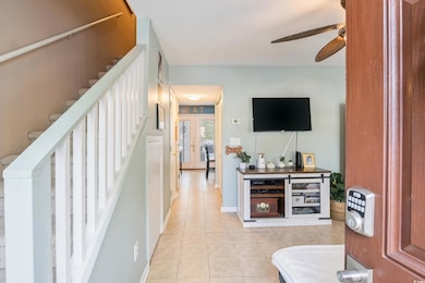Interior space with ceiling fan, light tile patter