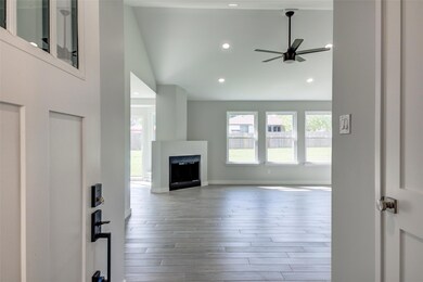 Unfurnished living room with ceiling fan, a firep