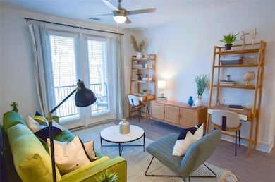 Living area with ceiling fan and hardwood / wood-s