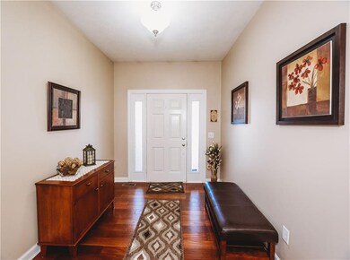 Entryway with beautiful gleaming hardwood floors.