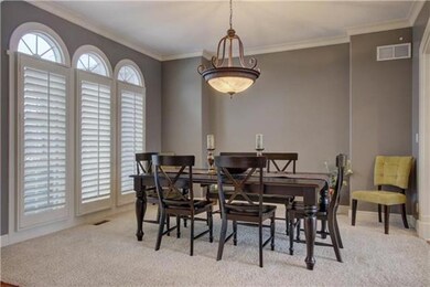 Plantation shutters and beautiful light fixture in