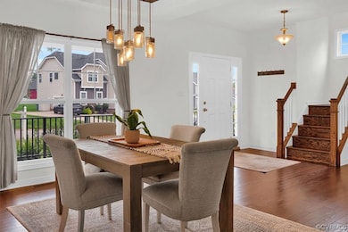 Wood floored dining area featuring a notable chand
