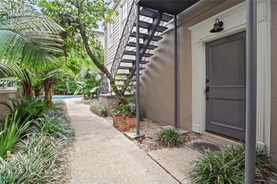 Front door on condo, and landscaped walkway to pool and yard.