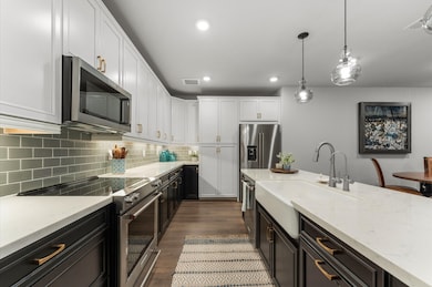 The kitchen features a modern design with sleek wh