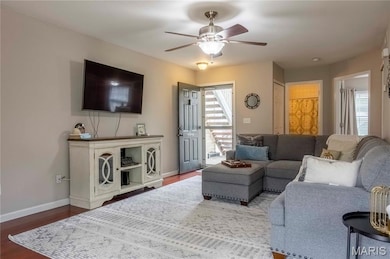 Living area with wood finished floors and a ceiling fan