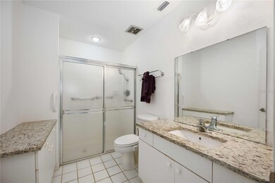 Primary En Suite Bathroom with Walk In Shower and Granite Countertops