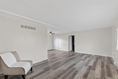Living Room Leading Into Dining Room and Den/Recre