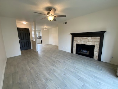 Unfurnished living room with ceiling fan and a tex