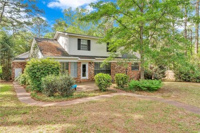 Traditional home with a front lawn, brick siding, 