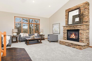 Your guests will step into a welcoming foyer complete with a gas fireplace and stunning views of the wooded lot right as they enter.
