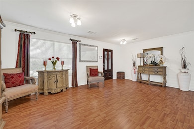 This spacious living area features ample natural light through large windows.