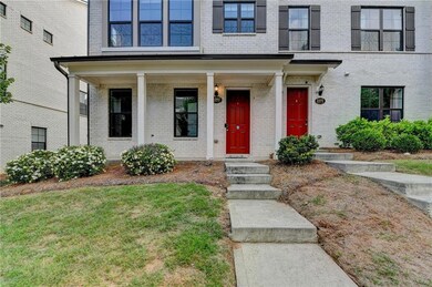Entrance to property with brick siding and a porch