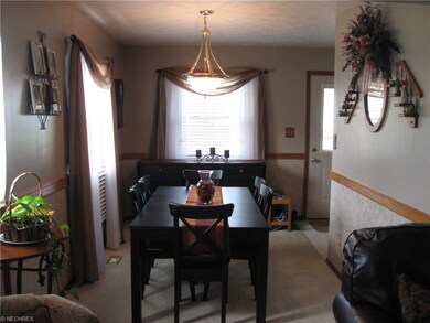 The dining room features neutral decor and is spac