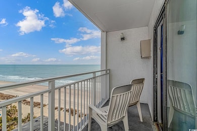Balcony featuring a beach view and a water view