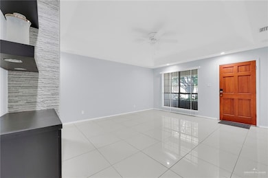 Unfurnished living room with a ceiling fan, tile patterned flooring, a raised ceiling, and recessed lighting
