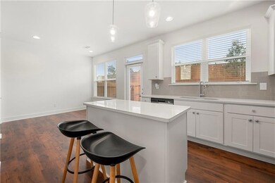 Kitchen featuring a sink, a center island, backspl