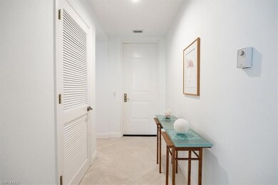Hall featuring visible vents, baseboards, and ligh