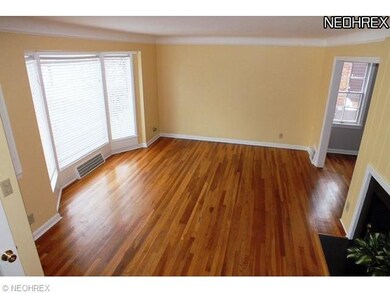 Living room has hardwood floors and wood burning f