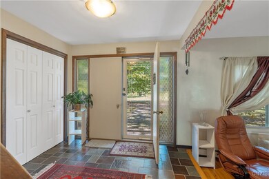 You are welcomed into the home through a double-door entry into a gorgeous flagstone foyer with a huge double coat closet.