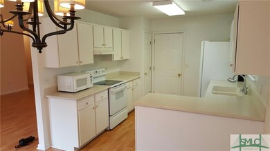 Another view of the kitchen, with door leading to 