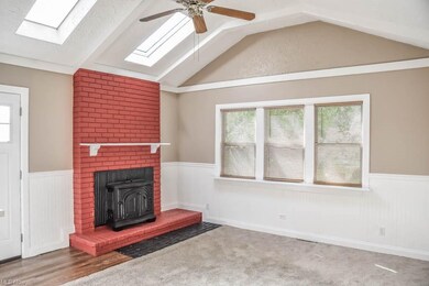 Back family room addition boasts a woodburning fir