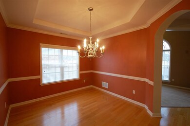 The dining room features a glittering light fixtur