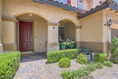 View of exterior entry with stucco siding and a ti