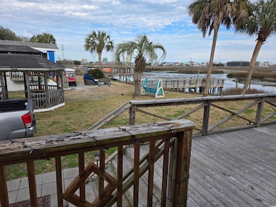 Dock area featuring a water view and a lawn