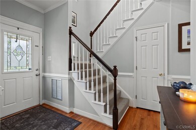 Entrance foyer with crown molding and light wood-t