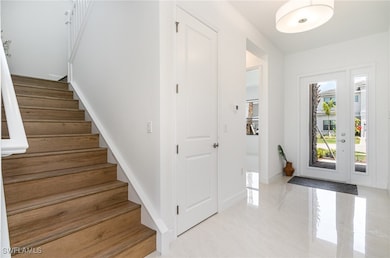 Entryway featuring stairway and baseboards