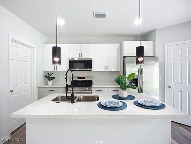 Kitchen with appliances with stainless steel finis