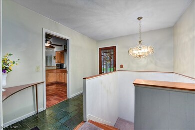 Corridor featuring a chandelier, dark tile flooring, and a textured ceiling