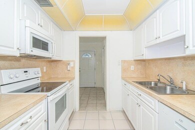Large galley kitchen leading out into the bonus ro