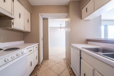 Kitchen featuring light tile patterned flooring, a