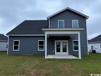 Rear view of property with a yard and a patio