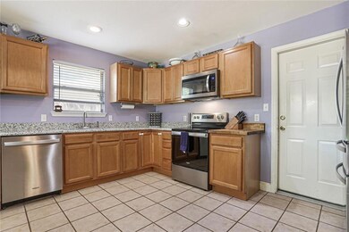 Spacious kitchen features newer stainless steel ap