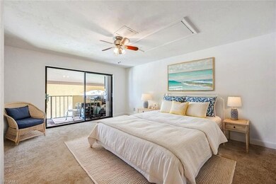 Carpeted bedroom featuring attic access, access to exterior, and ceiling fan