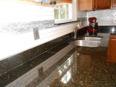 Granite counter top with new back splash tile.