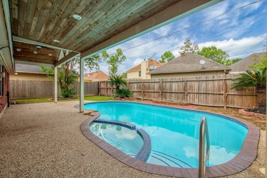 This photo showcases a backyard with a covered pat