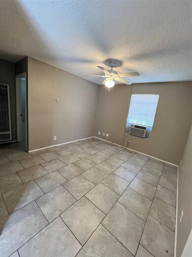 Empty room with baseboards, cooling unit, ceiling