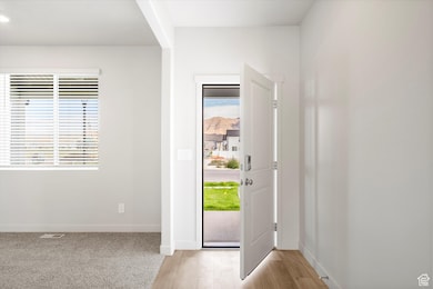 **DISCLAIMER - some exterior and interior options may vary**Foyer with baseboards and light wood finished floors